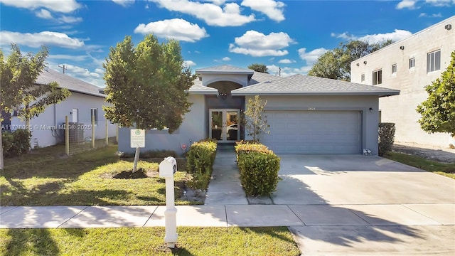 view of front of house featuring a garage and a front lawn