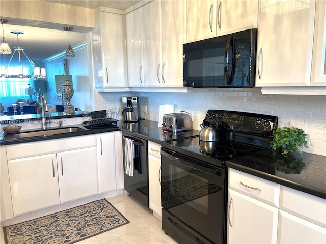 kitchen with decorative light fixtures, sink, white cabinets, and black appliances