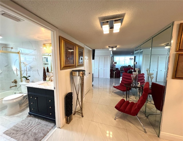 hallway featuring sink and a textured ceiling