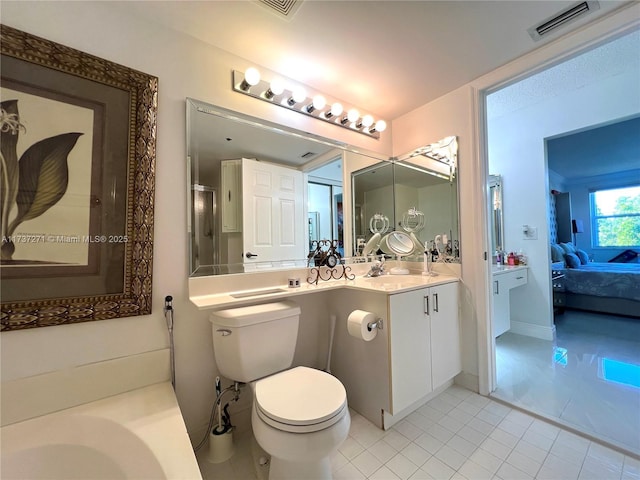 bathroom featuring vanity, tile patterned flooring, and toilet