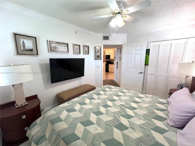 bedroom featuring ceiling fan, a closet, ornamental molding, and a textured ceiling