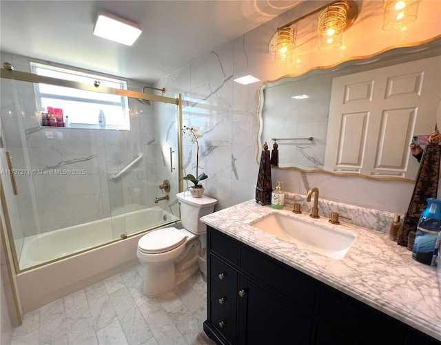 full bathroom featuring enclosed tub / shower combo, vanity, toilet, and tile walls