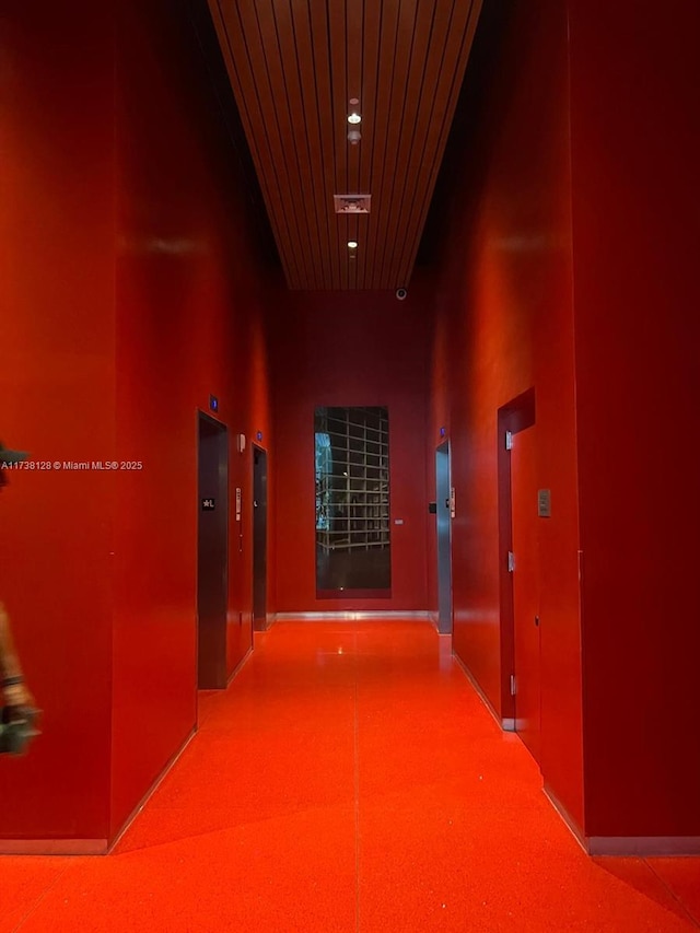 corridor featuring wood ceiling and a high ceiling