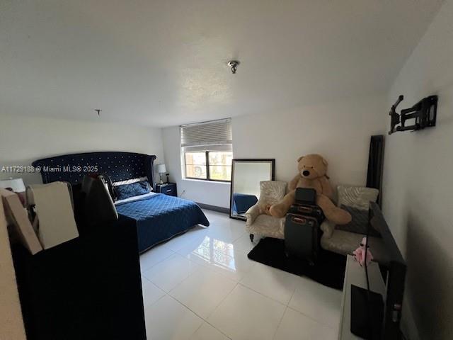 bedroom with light tile patterned flooring