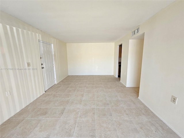 empty room with light tile patterned flooring and visible vents