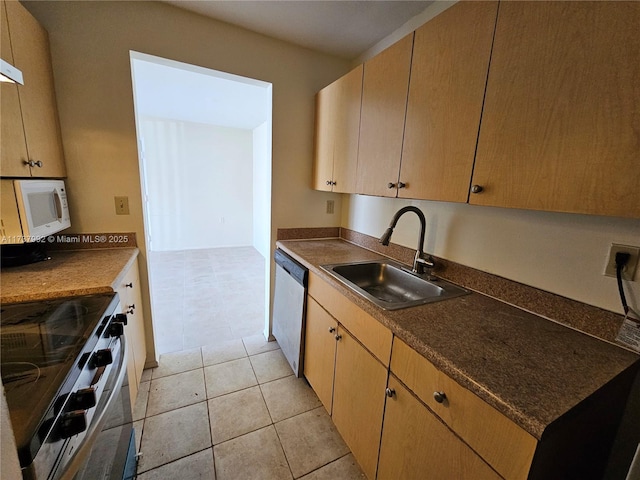 kitchen featuring sink, light brown cabinets, light tile patterned flooring, and appliances with stainless steel finishes