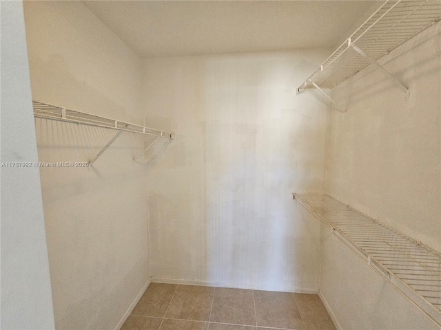 spacious closet featuring tile patterned floors