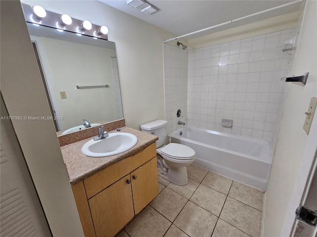 full bathroom featuring tile patterned flooring, vanity, tiled shower / bath combo, and toilet