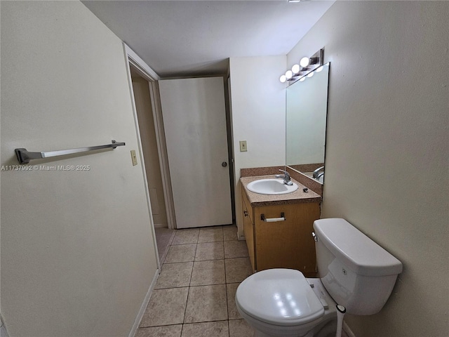 bathroom featuring vanity, tile patterned floors, and toilet