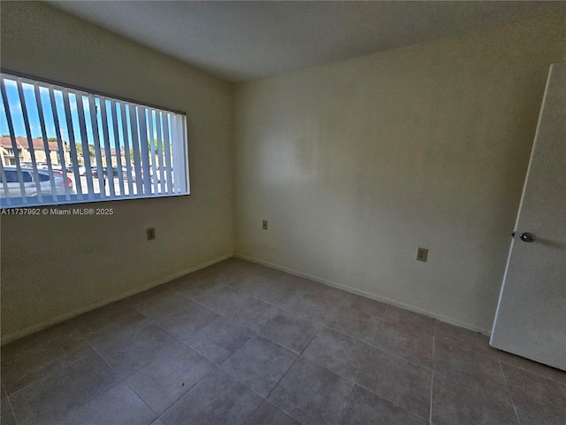 empty room with tile patterned flooring