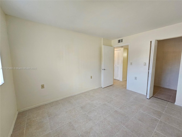 unfurnished bedroom featuring a closet and light tile patterned flooring