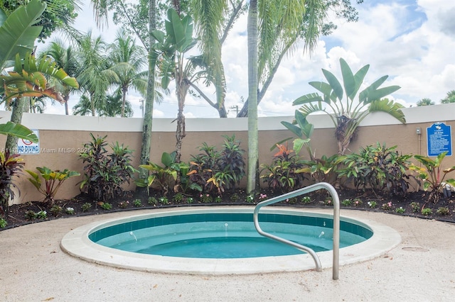 view of pool featuring fence