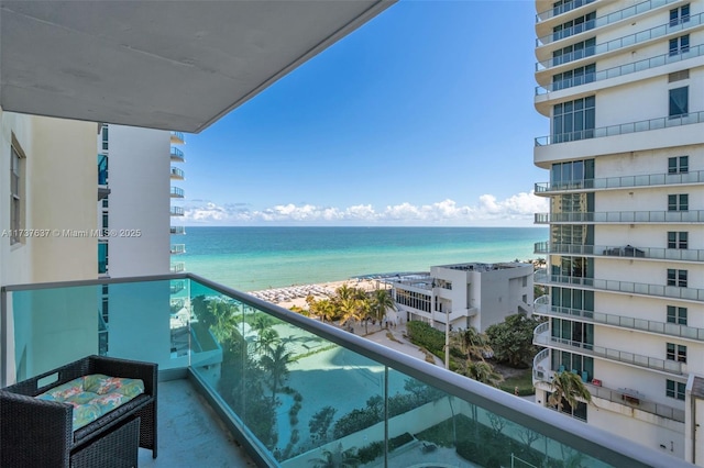 balcony with a beach view and a water view