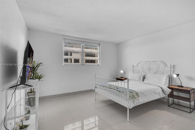 tiled bedroom featuring a textured ceiling