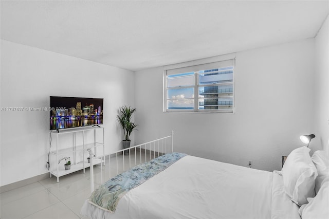 tiled bedroom featuring baseboards