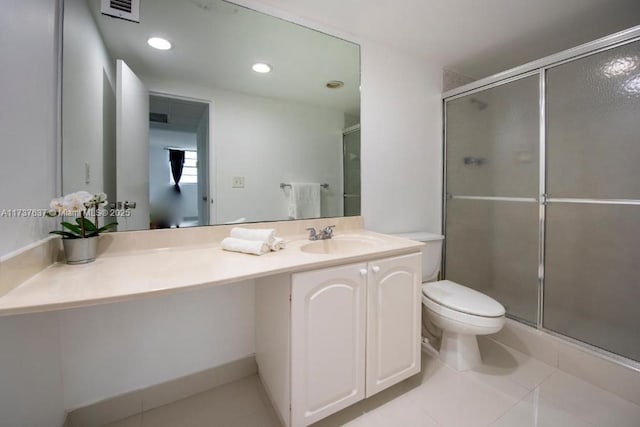 bathroom with vanity, tile patterned flooring, toilet, and walk in shower