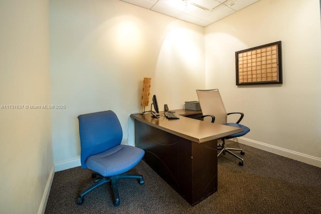 office space with a paneled ceiling and carpet