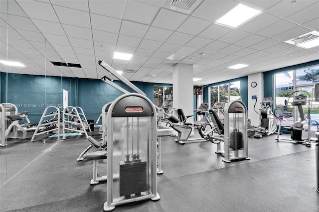 gym with a drop ceiling and visible vents