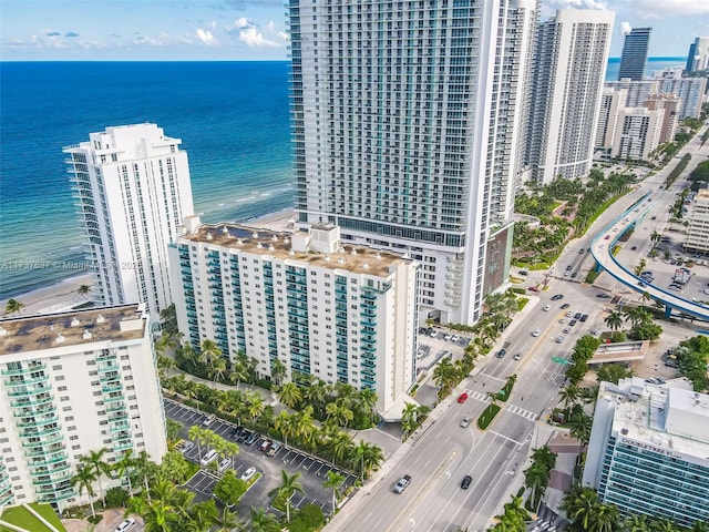drone / aerial view with a city view and a water view