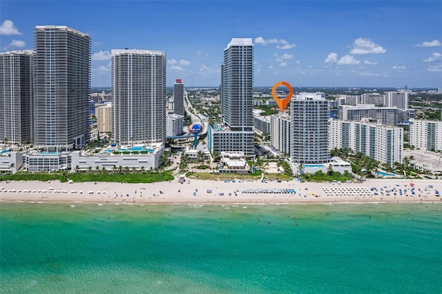 aerial view with a water view, a view of the beach, and a city view