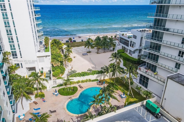 birds eye view of property with a water view and a beach view
