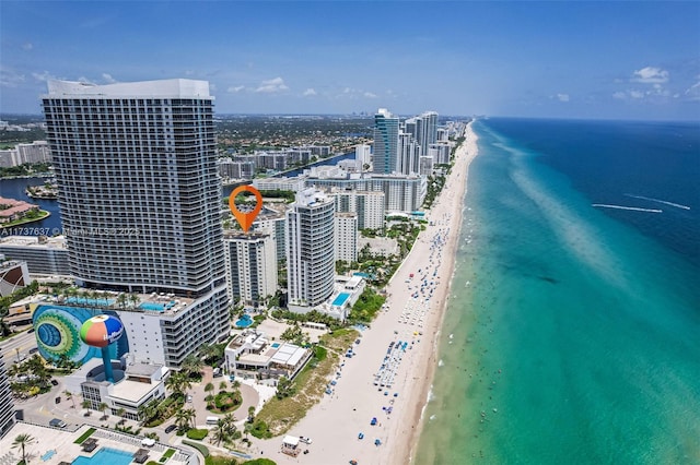 bird's eye view featuring a water view, a city view, and a view of the beach