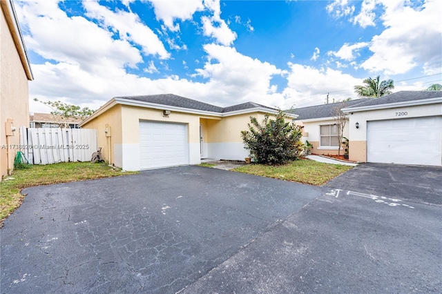 single story home featuring a garage and a front lawn