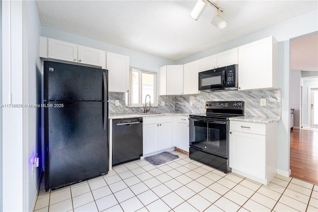 kitchen featuring white cabinetry, sink, tasteful backsplash, and black appliances