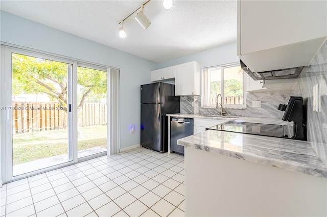 kitchen with tasteful backsplash, sink, white cabinets, light stone counters, and black appliances