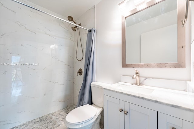 bathroom with vanity, toilet, and walk in shower