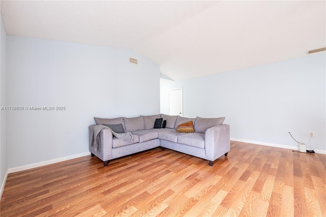 living room with lofted ceiling and light wood-type flooring