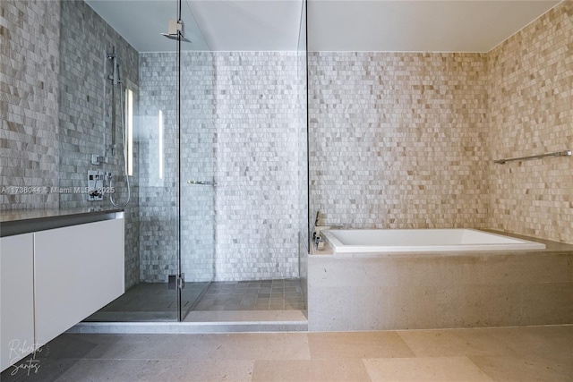 bathroom with tile walls and plus walk in shower