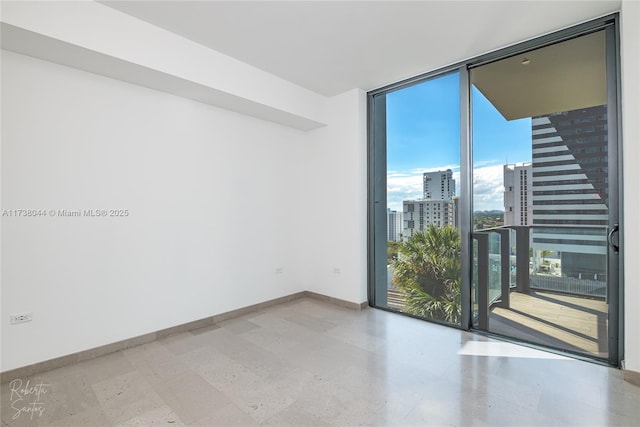 empty room featuring a wall of windows