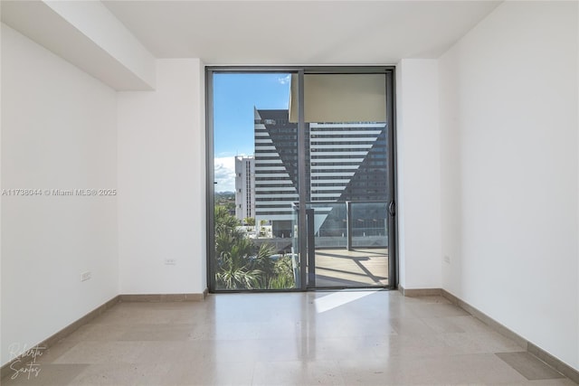 unfurnished room with floor to ceiling windows