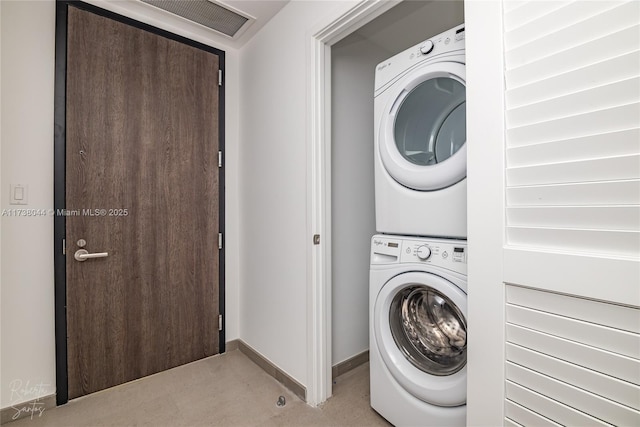 laundry room featuring stacked washer and clothes dryer