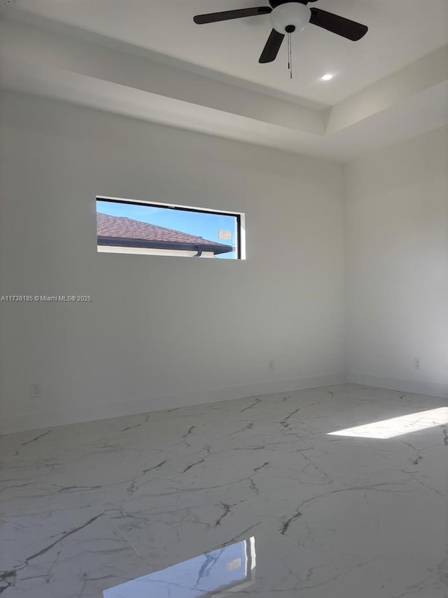 unfurnished room featuring a raised ceiling