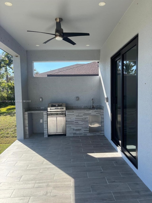 view of patio / terrace featuring exterior kitchen, area for grilling, sink, and ceiling fan