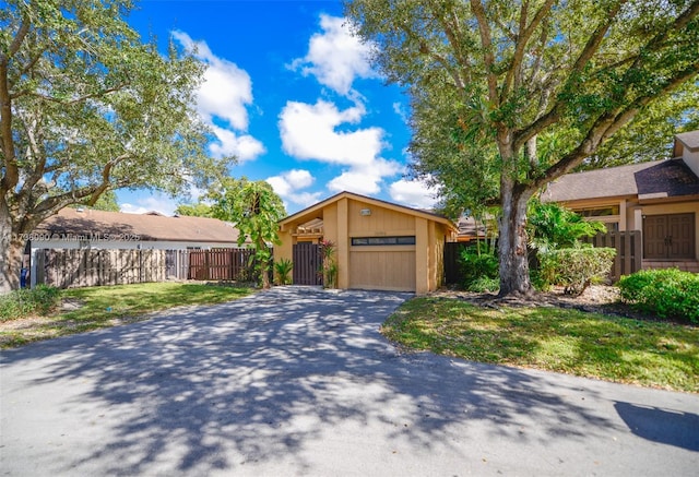 single story home featuring a garage and a front yard