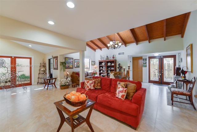 living room with french doors, a chandelier, lofted ceiling with beams, and wooden ceiling