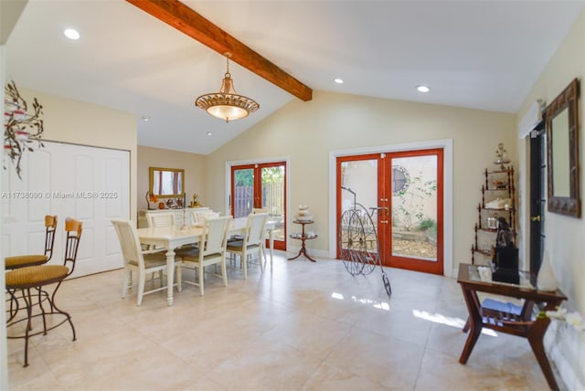 dining space featuring french doors and lofted ceiling with beams