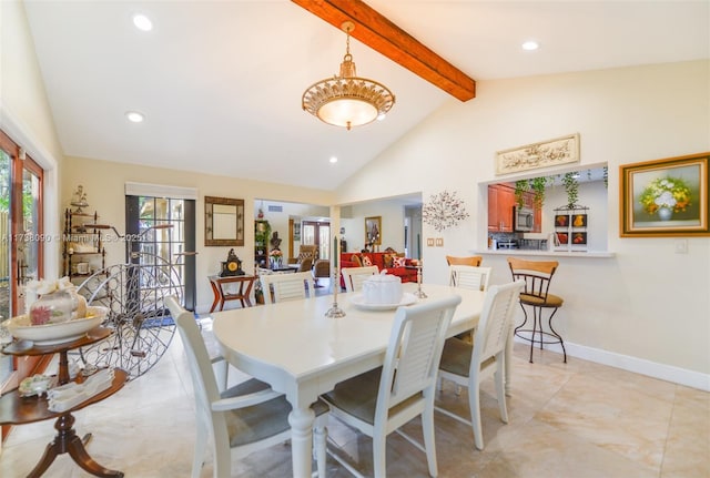 dining space with beamed ceiling and high vaulted ceiling