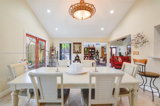 dining space featuring high vaulted ceiling and light tile patterned floors