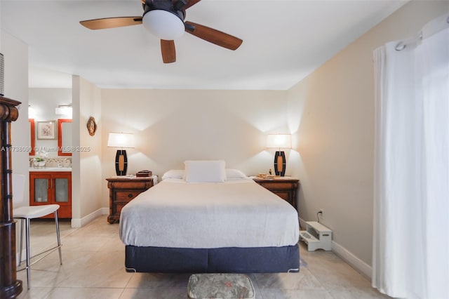 bedroom with ceiling fan, ensuite bathroom, and light tile patterned floors