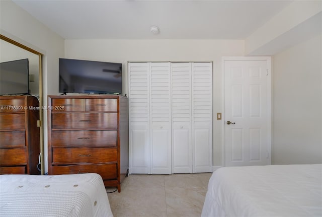 bedroom featuring light tile patterned flooring and a closet