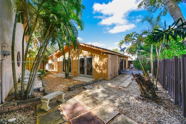 rear view of property with french doors and a patio area