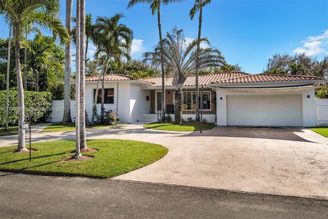 view of front of home with a garage and a front lawn