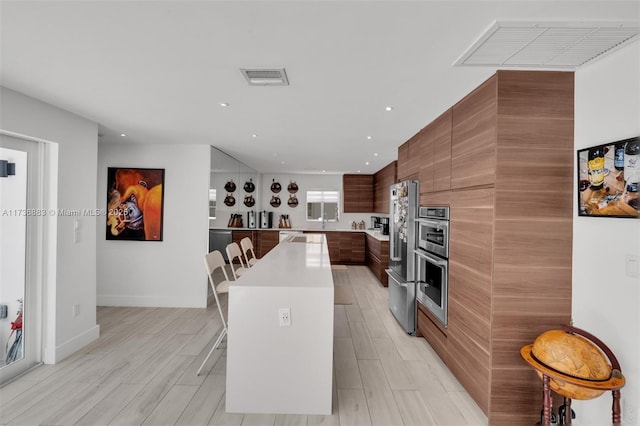 kitchen with stainless steel appliances, a center island, and a breakfast bar