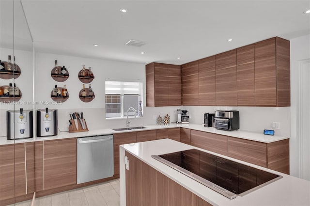 kitchen with stainless steel dishwasher, black electric stovetop, sink, and light tile patterned floors