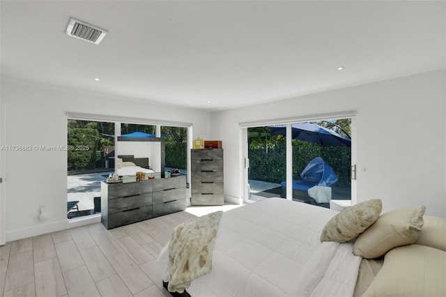 bedroom with access to outside and light wood-type flooring