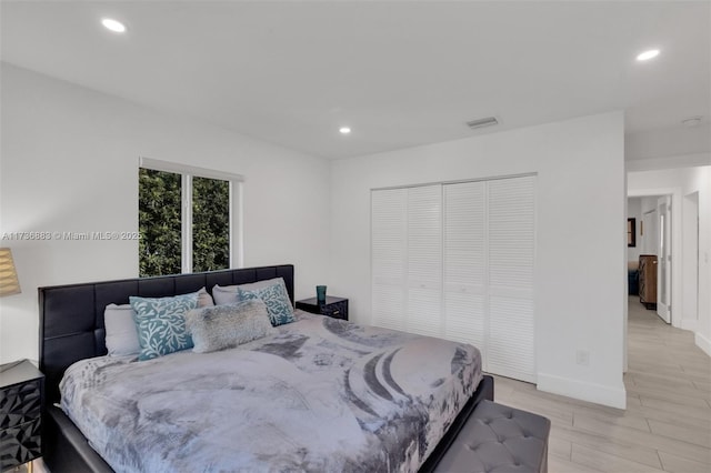 bedroom featuring light hardwood / wood-style flooring and a closet